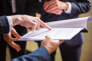 Professionals reviewing and discussing a document during a meeting.